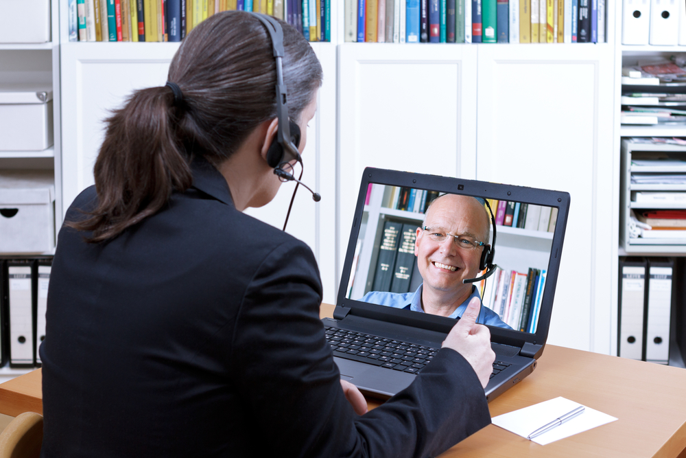 Attorney providing remote consultation to happy client
