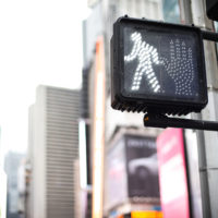 a crosswalk sign indicating that it is safe to cross
