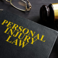 a personal injury lawbook gavel and glasses