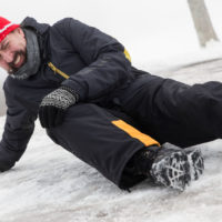 man falls due to icy ground