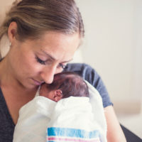 mother holding premature infant