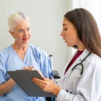 nursing home staff member assesses resident’s health