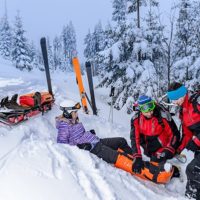 ski rescue team helping injured skier