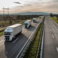 truck convoy travels down interstate