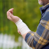 man with bandaged arm