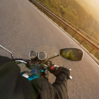 motorcyclist riding on mountain highway