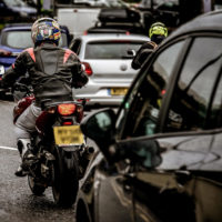 motorcyclist waits in traffic jam