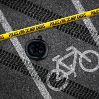 police tape and helmet in bike lane