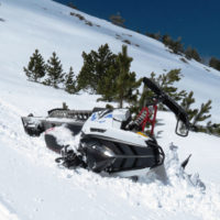 overturned snowmobile after crash