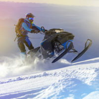 snowmobile-rider-jumps-hill